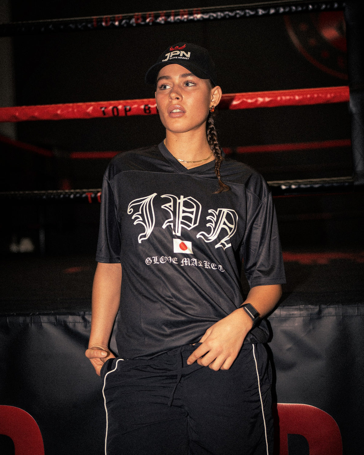 Model in the JPN Glove Market jersey and cap by the ring